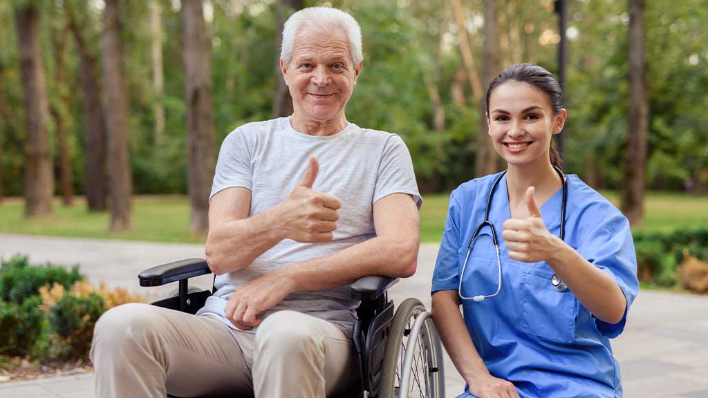 Professional-Caregivers posing beside elderly